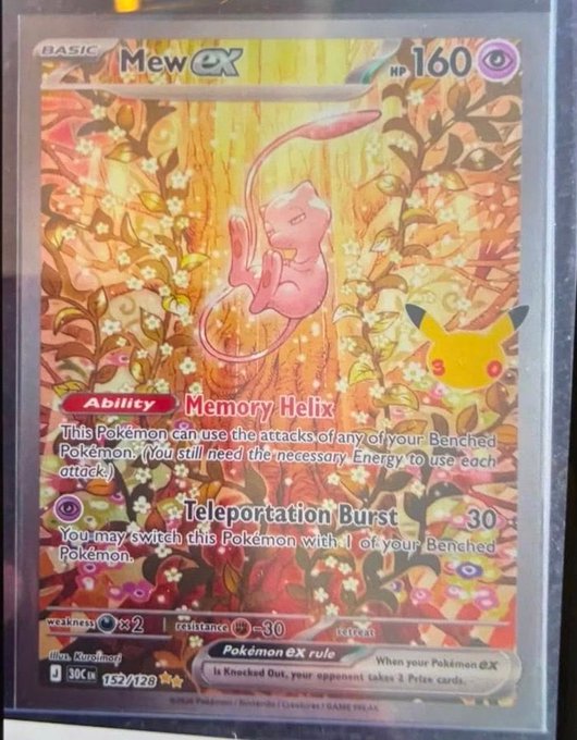 A photograph of a holographic Pokémon trading card featuring 'Mew ex' as a BASIC card with 160 HP, an Ability called 'Memory Helix', an attack 'Teleportation Burst' (30), numbered 152/120, and a 'Pokémon ex rule'.