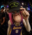 A stylized 3D cartoon character wearing a Lakers #8 jersey, pink hat, and sunglasses, set against a colorful cosmic background.