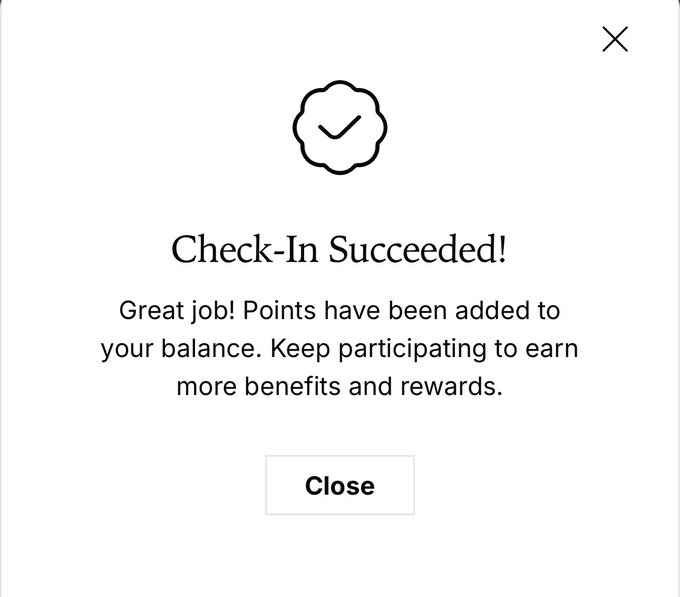A simple success notification popup with a checkmark icon reading 'Check-In Succeeded! Great job! Points have been added to your balance. Keep participating to earn more benefits and rewards.' with a 'Close' button.