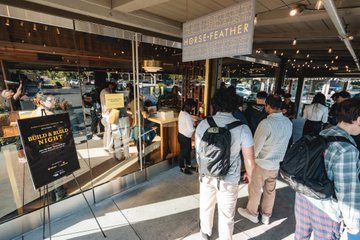 A crowd gathers inside Horsefeather for the Build N Build Night event hosted by YZi Labs and BNB Chain, with signage reading "BUILD N BUILD NIGHT" and "HORSEFEATHER" visible at the venue entrance.