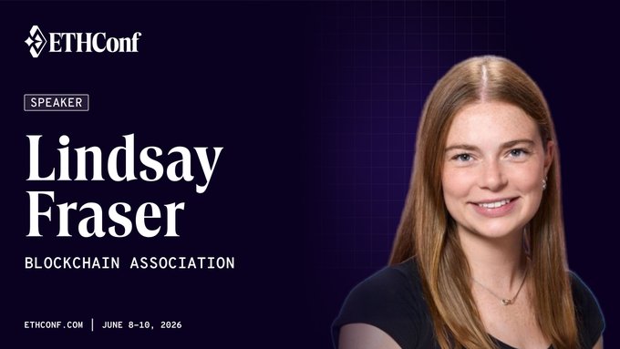 The image features a woman with long brown hair, wearing a black shirt, smiling at the camera as she poses for a photo. The background of the image is dark purple, which contrasts with her light-colored hair. In the bottom right corner of the image, there are some text elements that read "ethconf" and "Lindsay Fraser".