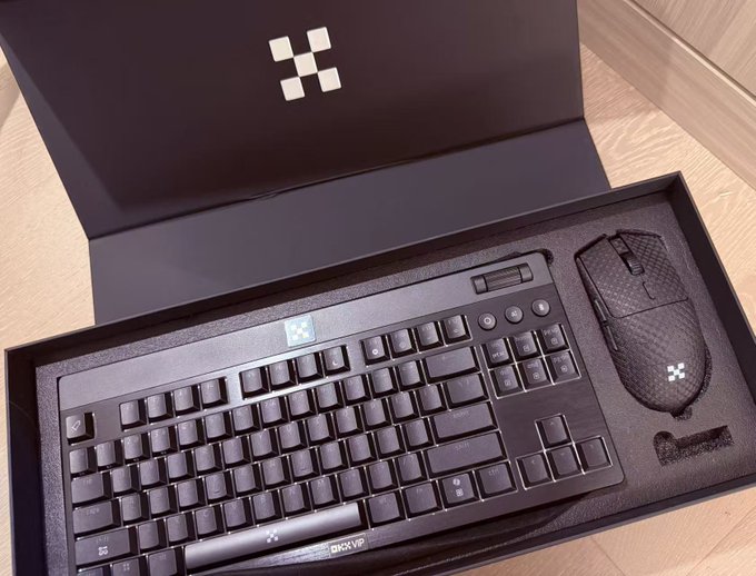 An unboxed black gaming keyboard and mouse combo set with a 'BIOVIVE' brand label, displayed in premium packaging with a cross/plus logo design.