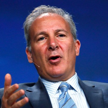 The image features a man wearing a suit with a blue necktie, standing against a blue backdrop while speaking into a microphone. He appears to be a well-known expert or businessman who has made significant contributions in various fields such as finance and real estate. The main focus of the image is Peter Schiff's recent statement about Bitcoin and its potential impact on currency markets.