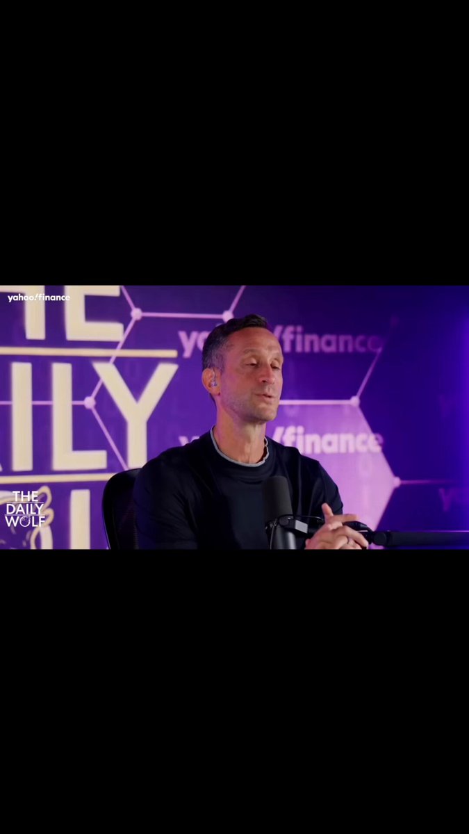 The image features a man sitting at a desk, wearing a black shirt. The background of the image is purple, which appears to be part of an advertisement or promotional material for something related to Bitcoin. The text "Hats not to see Scott' passion but it is well documented from special agent Rana Saoud from Homeland Security that they interviewed the 4 Satoshis, not one guy." This suggests that there might be a connection between the man in the image and the Bitcoin project or event being advertised.