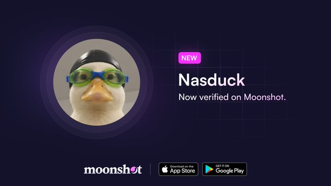 A promotional graphic with a dark purple background features a circular photo of a rubber duck wearing blue and green swimming goggles, accompanied by a "NEW" badge and the text "Nasduck - Now verified on Moonshot." At the bottom, the Moonshot logo appears alongside App Store and Google Play download buttons. The image visually announces the verification of the Nasduck project on the Moonshot platform, matching the accompanying post.