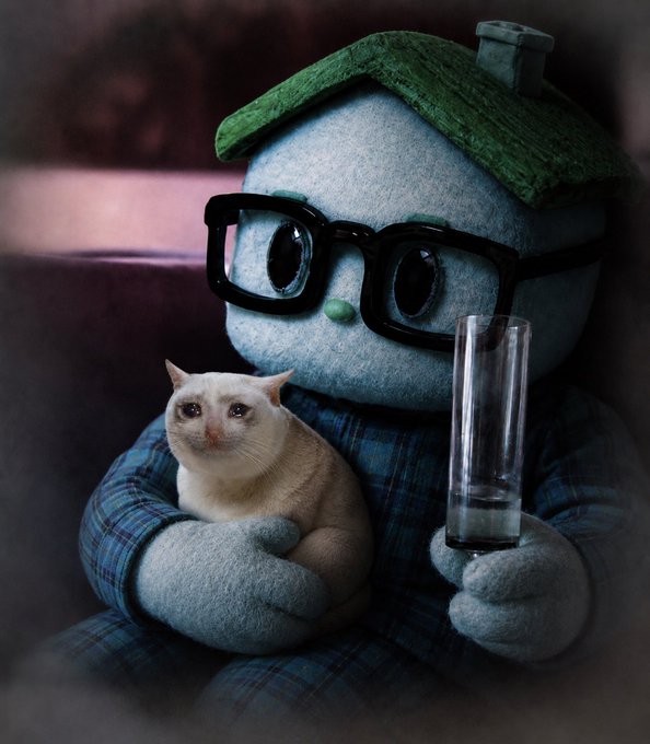 A plush toy figure of a character with glasses and a green hat holding a cat and a glass, rendered with a moody, dark aesthetic.