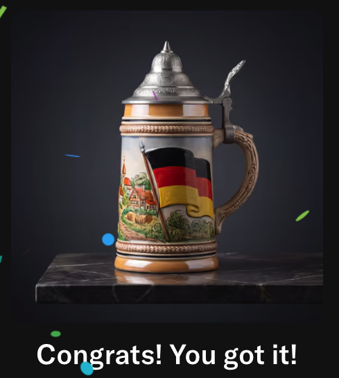 The image features a mug with an illustration of the German flag, which has been used as a gift for someone's birthday. The mug is placed on top of a marble countertop or table, adding elegance to its presentation. The text "Congratulations! You got it!" is written in the bottom right corner of the photo, indicating that the mug was recently received and appreciated by the recipient.