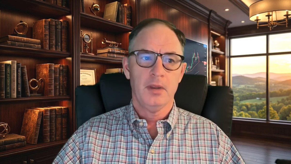 A man wearing glasses sits behind a desk with bookshelves filled with books around him, looking at the camera. A window can be seen in front of him, allowing natural light into the room. The caption for the image reads "The Sun Will Shine On XRP Watch The Full Youtube Video Here: youtu.be/9pvlwPN0oBU".