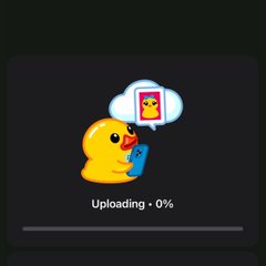 A dark-themed upload progress screen displaying a cute yellow duck holding a phone, with the text 'Uploading · 0%' beneath a thought bubble.