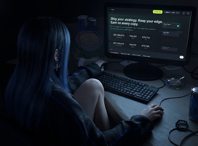 A woman with dark hair sits in a dimly lit room using a computer that displays a crypto trading screen reading 'Ship your strategy. Keep your edge. Earn on every copy.'