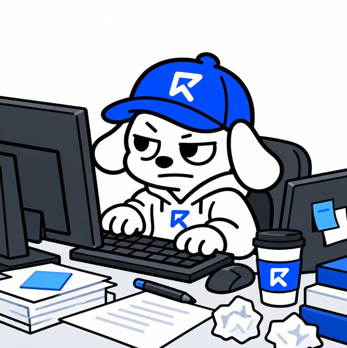 Cartoon illustration of a white dog mascot wearing a blue cap and hoodie, both branded with an 'R' logo, sitting at a cluttered desk typing on a keyboard.
