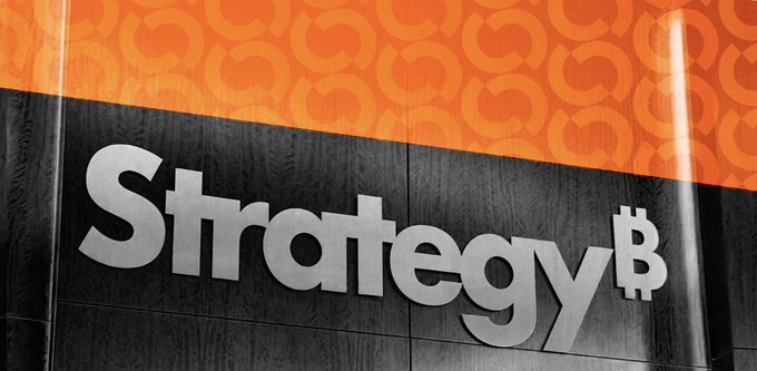 The image shows a sign reading "Strategy₿" in silver lettering on a dark wooden background, with an orange banner above featuring circular logo patterns. This relates to the accompanying post about $MSTR (MicroStrategy/Strategy), the company formerly known as MicroStrategy that has embraced Bitcoin (symbolized by the ₿ in the logo) as a core part of its corporate treasury strategy, with the post discussing executive compensation tied to the company's Bitcoin-focused business model.