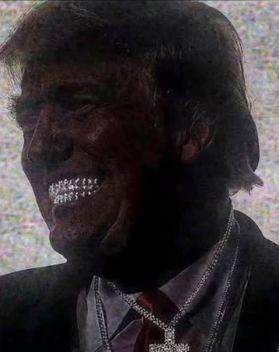 A grainy, dark photograph of a smiling man wearing a suit and red tie, adorned with multiple silver chains.