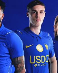 A male soccer/football player wearing a blue jersey with 'USDC BY CIRCLE' sponsorship visible on the front.