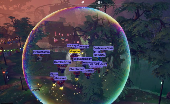 A video game screenshot showing multiple players inside a large iridescent bubble, with usernames visible including Mr.Customm, HamBearPig, Dippy, Makaveii, Chef Indica, BigNazHappy, Mike, OLIVER-GUI7, Smokey97, Grotesque Chris, M-H, TOPGUNS, -hypha-, and Izanzy.