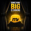 A promotional graphic for MTV's announcement of 'SOMETHING BIG IS COOKING,' displayed on a stage with curtains drawn open.