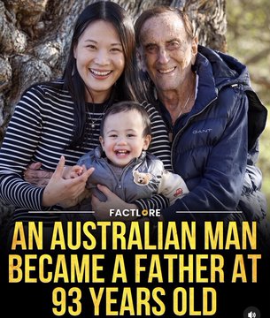 A photo of an older man, a woman, and a baby sitting outdoors, with text reading "AN AUSTRALIAN MAN BECAME A FATHER AT 93 YEARS OLD" and a "FACTLORE" logo.