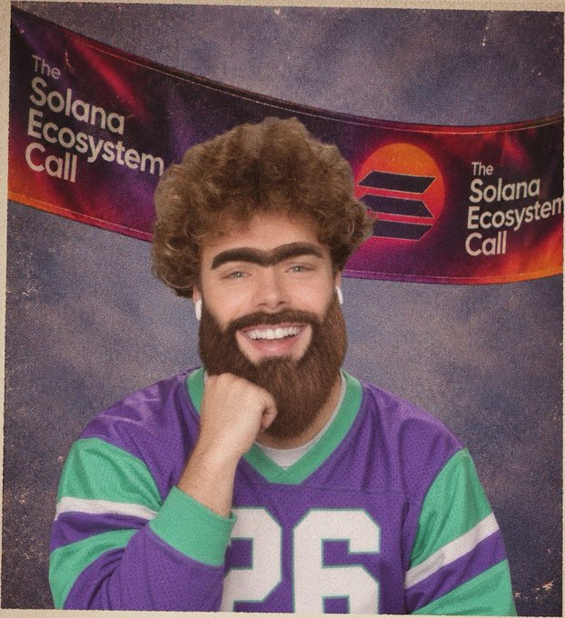 A person wearing a curly brown wig, a fake beard, and a purple and green jersey poses in front of a banner that reads 'The Solana Ecosystem Call'.