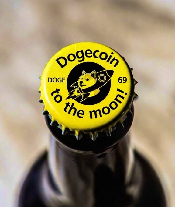 A close-up of a bottle cap with a yellow Dogecoin label, featuring the Shiba Inu rocket logo and the text “Dogecoin,” “DOGE,” “69,” and “to the moon!”