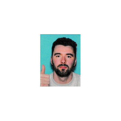A man with dark hair and a beard giving a thumbs up against a bright turquoise background, set against a larger white background.