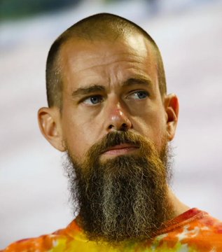 A close-up photo of a bearded man in a tie-dye shirt is shown, though no clear text, name, or identifying features are visible in the image itself. The post about Jack Dorsey's Block adding Bitcoin is unrelated to the person pictured.