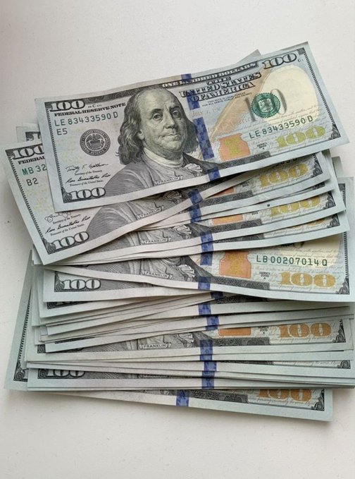 A stack of U.S. $100 bills fanned out on a white surface, with visible serial numbers like LE83433590D and LB00207014D, embodying the post's caption about "future money makers"—symbolizing the wealth and prosperity reserved for those aligned with the algorithm's favor.