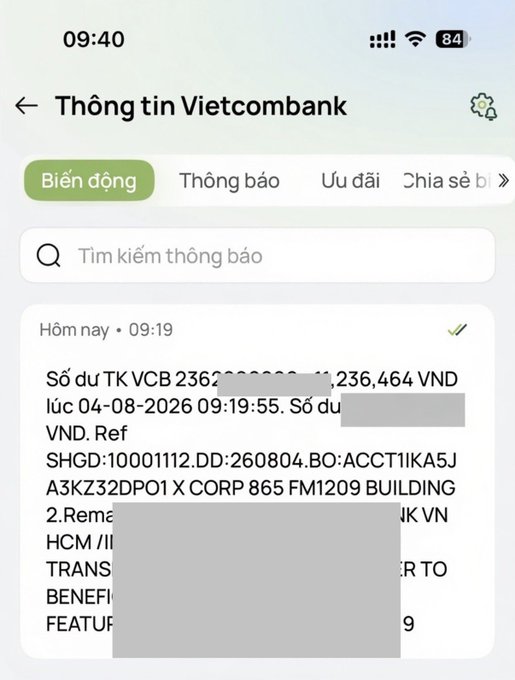 A Vietcombank notification showing an account balance of 1,236,464 VND, partially redacted with text referencing "ACCT1KA5JA3KZ32DP01 X CORP 865 FM1209 BUILDING 2" and other transaction details.