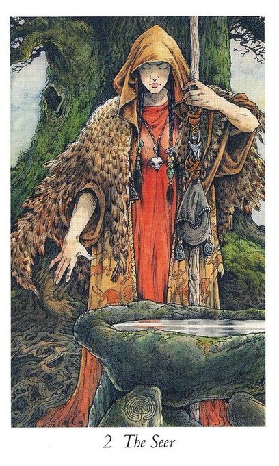 A tarot card labeled '2 The Seer' depicts a hooded figure in a yellow cloak and red dress standing next to a stone basin.