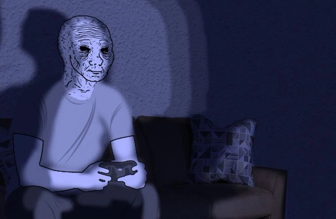 A figure wearing a wrinkled, alien-like mask sits on a couch holding a game controller in a dimly lit blue room, illustrating the post's lament about misguided web3 gaming projects that fail to retain players, suggesting a unified gamerscore-style system could have sustained engagement.