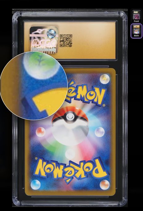 A graded Pokemon trading card in a protective slab (PSA-style case) showing the iconic Pokéball back design, with a magnified zoom-in circle highlighting a specific area of the card's artwork.