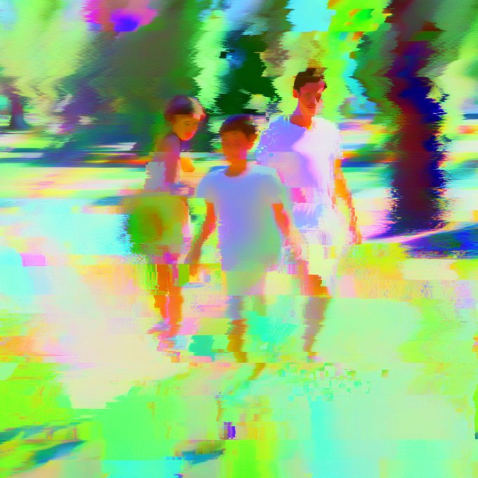 A distorted, glitch-style image shows three figures walking outdoors, heavily saturated with neon green, pink, and purple digital artifacts.