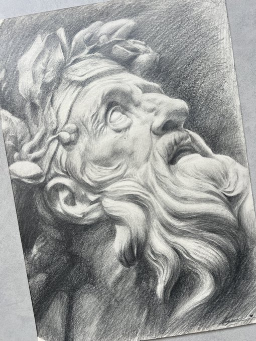 A detailed graphite sketch of a classical marble sculpture depicting a bearded man's head in dramatic upward gaze, perfectly capturing the sculptural quality through skilled shading and contrast. The monochrome pencil work aligns with the "Monochrome Monday" theme, while the sculpted flowing beard and headband echo the playful "soapy" tone.