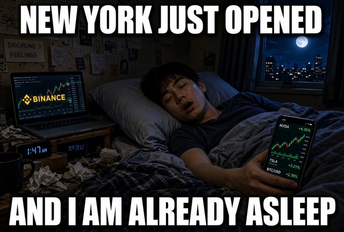 A meme-style image showing a man sleeping in bed with a laptop displaying Binance charts and a smartphone showing stock tickers like NVDA, TSLA, and BTC/USD, captioned 'NEW YORK JUST OPENED AND I AM ALREADY ASLEEP'.