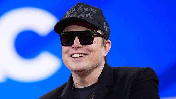 The image features a man wearing sunglasses, a black baseball cap with "America" written on it, and a suit jacket. He has a smile on his face as he looks directly at the camera. The caption of the image reads "Pump fun should study this." This suggests that the man is promoting an idea or concept related to pump fun, possibly in relation to America's history or culture.