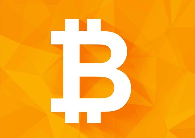 The image features the Bitcoin (₿) logo prominently displayed in white against an orange geometric/polygonal background, symbolizing cryptocurrency. This relates to the post about Indian citizens now being able to use crypto for domestic purchases through digital gift cards and vouchers via overseas fintech platforms, highlighting Bitcoin as the leading cryptocurrency enabling this new payment avenue.