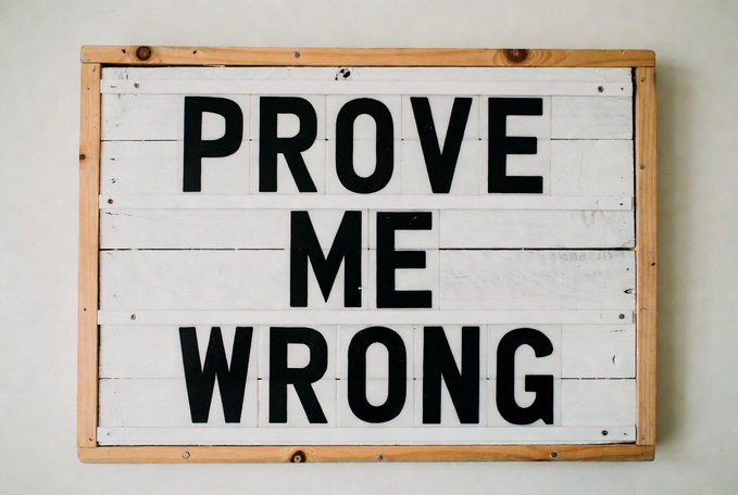 A rustic white wooden sign with bold black letters reads "PROVE ME WRONG," challenging viewers to dispute a bold claim—in this case, the post's assertion that the Class of 2017 are the most toxic Bitcoin maxis. The confrontational phrase serves as an invitation for the crypto community to either back up the statement or present a counterargument.