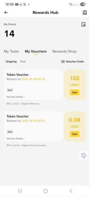 The image shows a phone screen displaying a rewards hub page, which includes two lists of rewards for Bitcoin and Gold. The rewards are listed with their respective amounts, and there's also information about the event that led to these rewards. The text on the screen reads "Alhamdulillah! Grateful to receive my reward from the Binance BTC vs Gold Event. Proud to secure a spot in the Top 20 leaderboard with 67 new traders joining through Riyads Creation Received 102 USDC as an eligible referrer reward." This post is related to the rewards hub, and it highlights the achievements of the users who joined the event for Bitcoin or Gold.