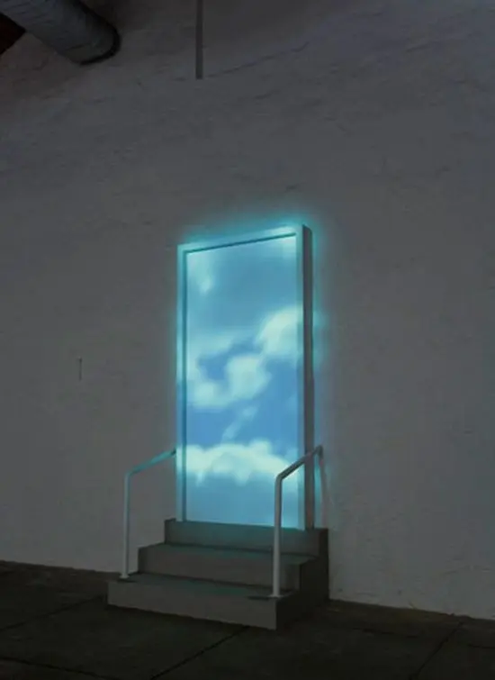 An installation art piece showing an illuminated rectangular doorway displaying an image of blue sky and clouds, accessed by a small set of stairs in a dimly lit room.