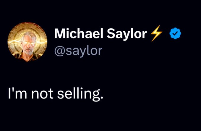 A black background with a gold circle and the text "Michael Saylor" and "@Saysor" on it, accompanied by a blue checkmark symbolizing a negative sentiment.