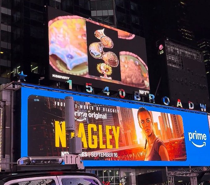 Times Square billboards at night displaying NFTs and a Prime Video advertisement for the movie 'Nagles' premiering September 16.