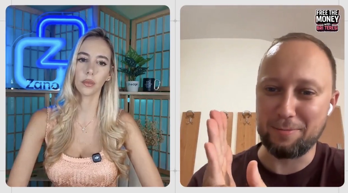 Split-screen video call from the "FREE THE MONEY with BRIT TERESI" show featuring a blonde woman in a peach top in front of a blue "Zano" neon logo on the left, and a bearded man in a maroon shirt wearing an earpiece on the right, set against wooden coat hooks.