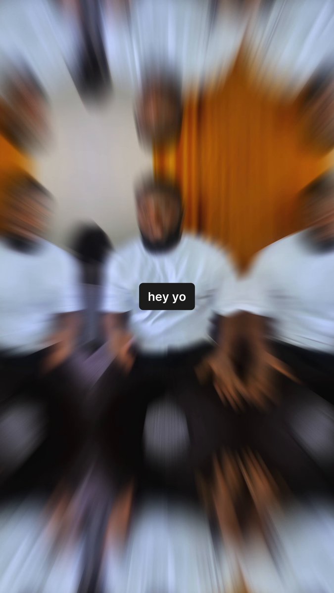 The image features a blurry photo of people sitting around a table with a clock in the background. The caption for the image reads "hey yo" which suggests that there might be an early registration or reward system related to the game being played, possibly involving the clock and the players' names.