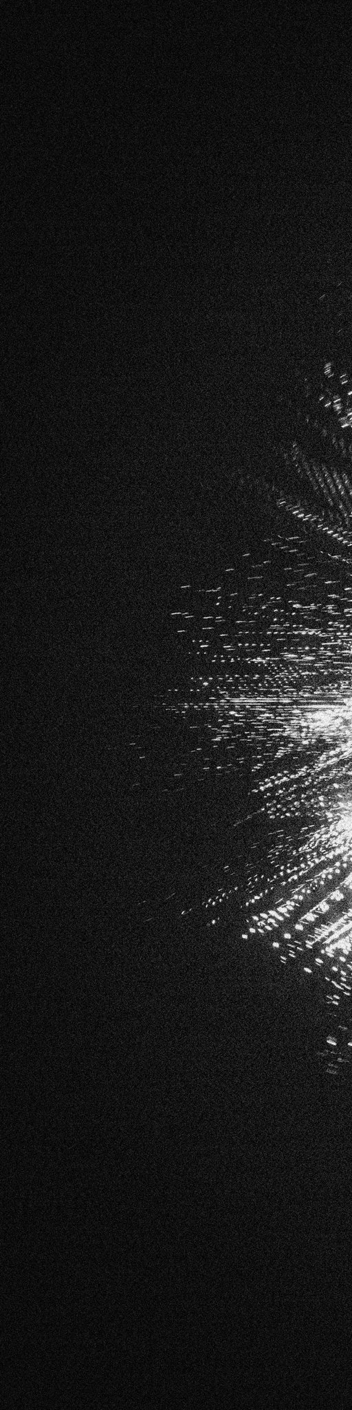 A dark, mostly black image with abstract white glitchy static and light streaks appearing along the right edge, creating a distorted digital effect.