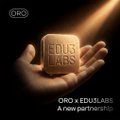 A hand holds a glowing block displaying "EDUS LABS" against a dark background, with the text "ORO + EDUSLABS: A new partnership" below. The image introduces a new collaboration between ORO and Edus Labs, aligning with the post's focus on guiding newcomers through the complex and jargon-heavy DeFi ecosystem.