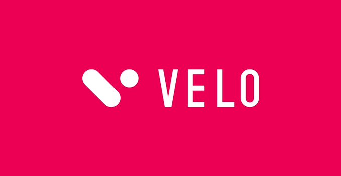 Velo brand logo displayed in white text and symbol on a bright pink background.