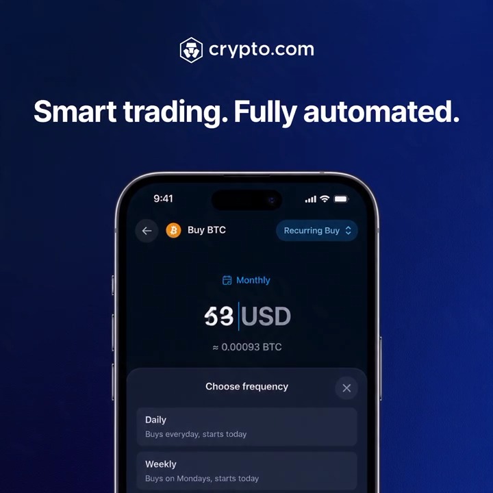 A Crypto.com promotional graphic featuring the headline "Smart trading. Fully automated." above a smartphone mockup displaying the app's Recurring Buy interface, which shows a $53 USD monthly purchase of BTC (≈0.00093 BTC) with options to choose Daily or Weekly frequency—directly illustrating the post's message about automating crypto purchases on a set schedule.