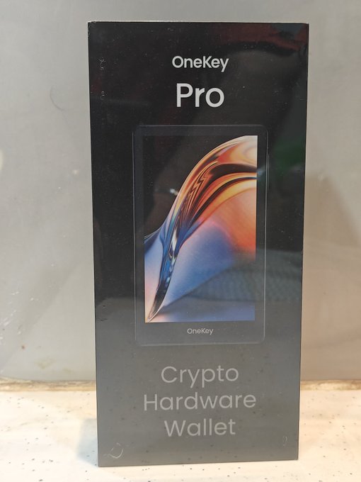 The image shows the box for a OneKey Pro Crypto Hardware Wallet, ready for unboxing.