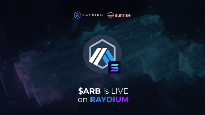 A promotional graphic featuring the Raydium and Sunrise logos at the header, with a central hexagonal emblem displaying intertwined blue and white symbols against a dark, cosmic-style background. The bold text below announces "$ARB is LIVE on RAYDIUM," visually reinforcing the announcement of ARB being tradeable on the Raydium DEX via Sunrise on Solana.