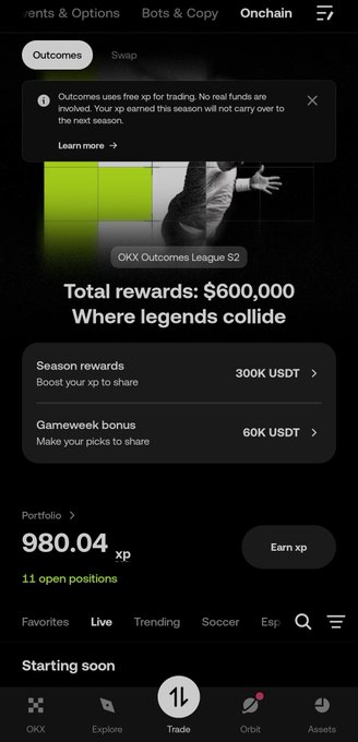 The OKX app's 'Outcomes' trading tab displaying 'OKX Outcomes League S2' with $600,000 in total rewards, including 300K USDT season rewards and 60K USDT gameweek bonuses, with a portfolio of 980.04 XP.