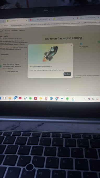 A laptop screen displays a Project Alchemy / Marketcall onboarding page with a pop-up message "You passed the assessment! Finish your onboarding so you can get started backing."